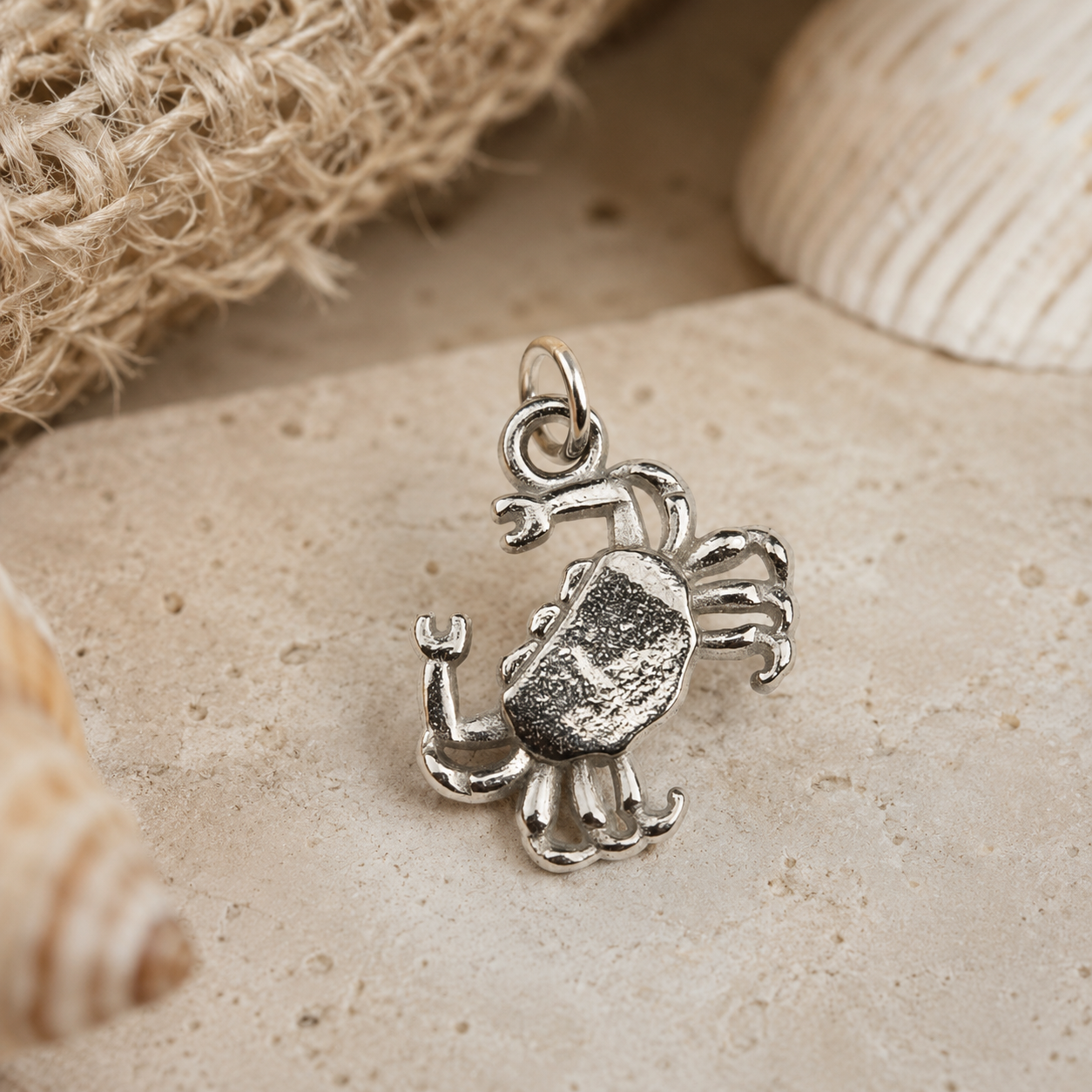 Pewter Crab Charm on a soft linen background