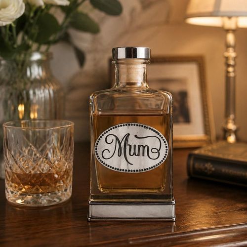 A glass flask with a pewter base and a handcrafted pewter “Mum” emblem on the front