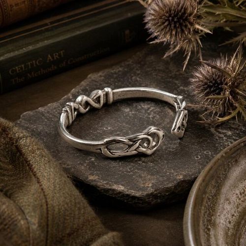 Intricate Celtic knotwork pewter torc bangle featuring woven open-cuff detailing