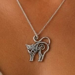 An openwork pewter pendant shaped like a stylized cat with an arched back, featuring intricate Celtic knotwork detailing within its body
