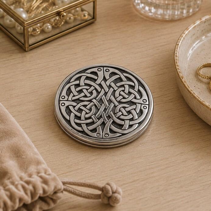 Round pewter compact purse mirror featuring an intricate, continuously interlaced Celtic knotwork design covering the lid