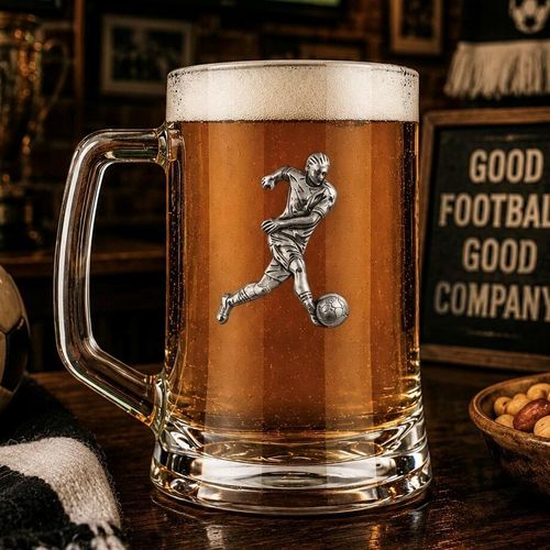 A Beer Tankard with a Pewter Football badge on the front, filled with Amber Beer