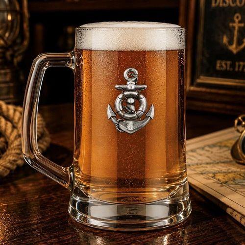 A Beer Tankard with a Pewter Anchor badge on the front, filled with Amber Beer