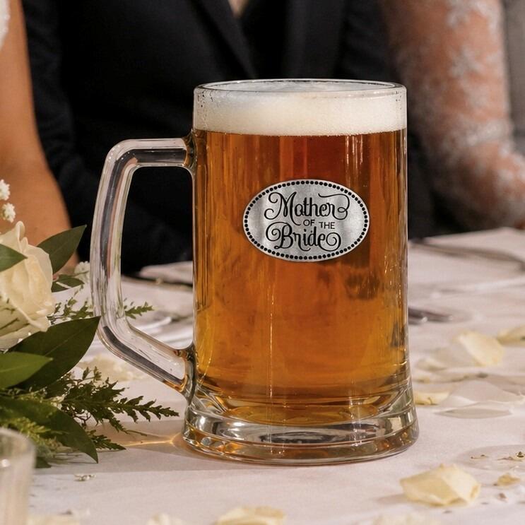 A Beer Tankard with a Pewter Mother Bride badge on the front, filled with Amber Beer