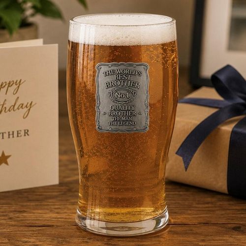 One-pint filled with lager, featuring a detailed pewter plaque that reads 'The World's Best Brother, No.1 Quality Brother, The Man The Legend', presented on a wooden table next to a gift box