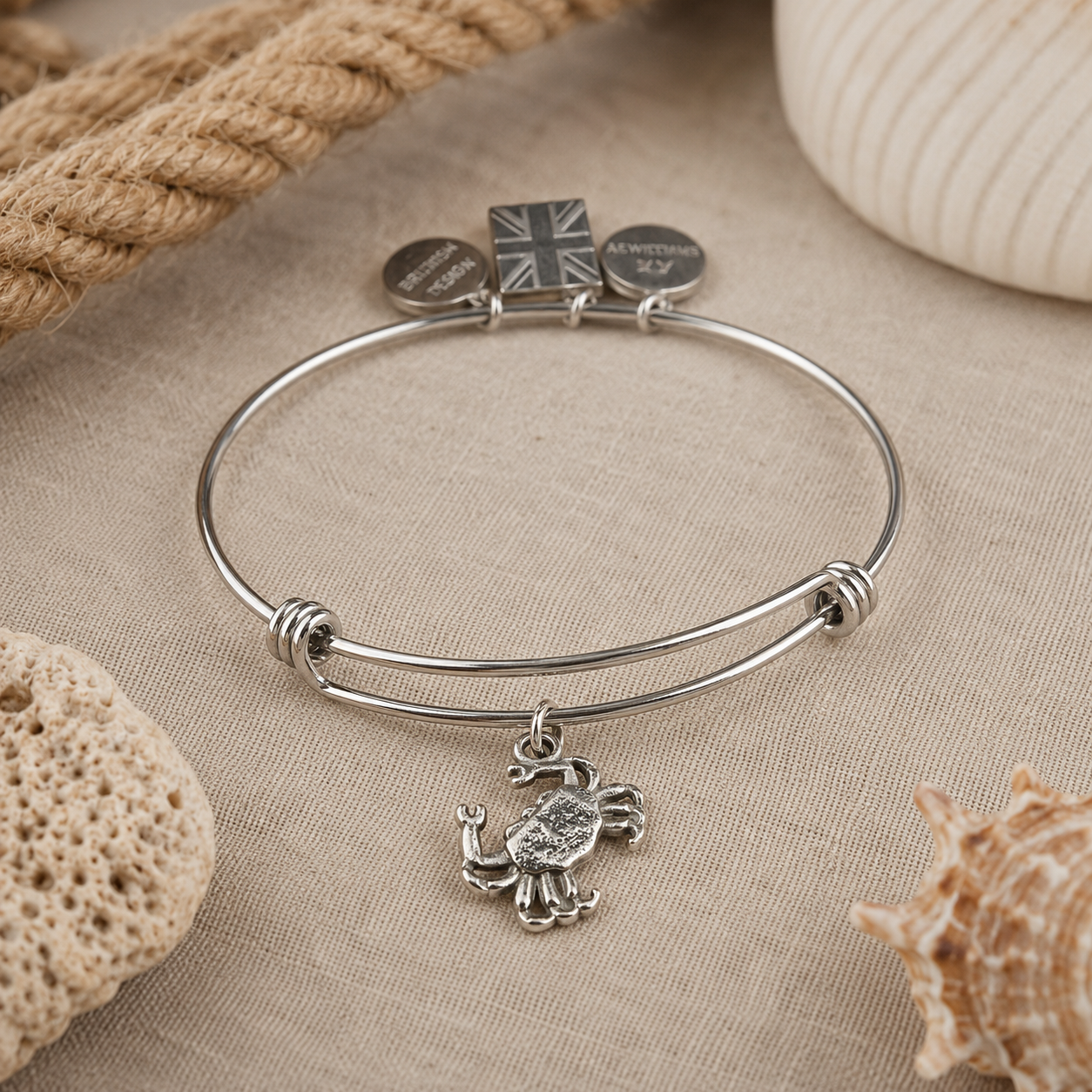 Pewter Crab Charm attached to a charm bracelet with other pewter charms attached
