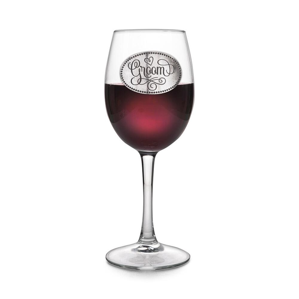 Wine glass with handcrafted pewter Groom badge filled with red wine