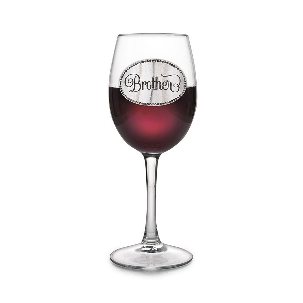 Wine glass with handcrafted pewter Brother badge filled with red wine