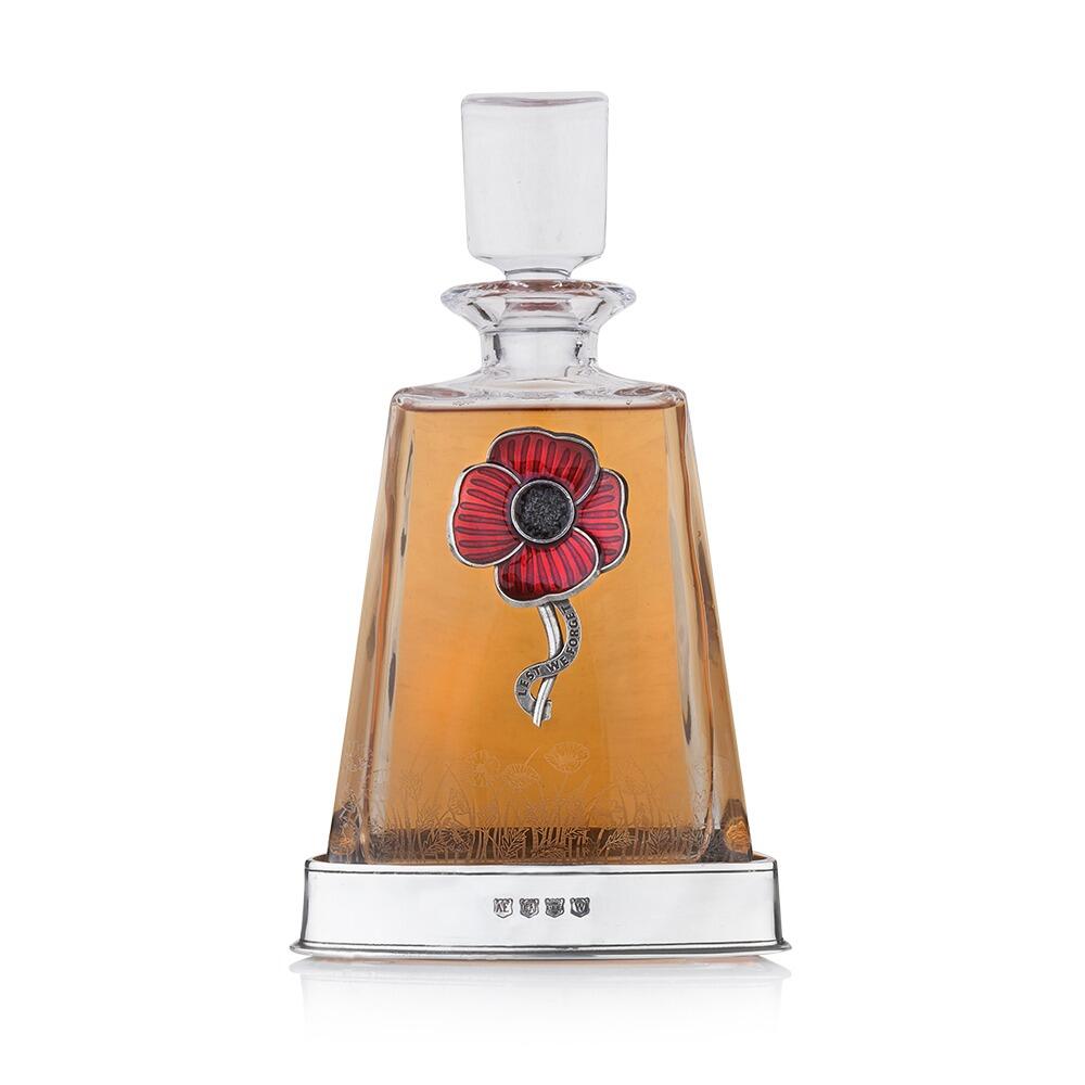 Crystal decanter with hand-enamelled red pewter poppy badge and polished pewter base filled with amber spirit