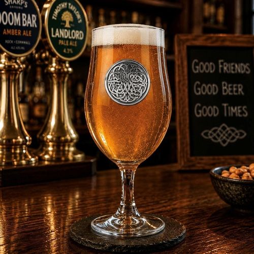 A Stemmed Pint Beer Glass with a Pewter Never Ending Knot badge on the front, filled with Beer