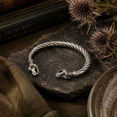 Viking-style twisted pewter torc bangle featuring sculpted dragon head terminals