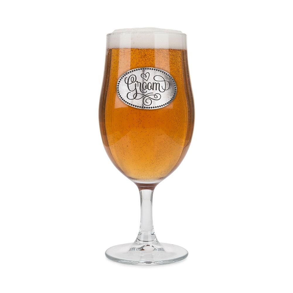 A Stemmed Pint Beer Glass with a Pewter Groom badge on the front, filled with Beer
