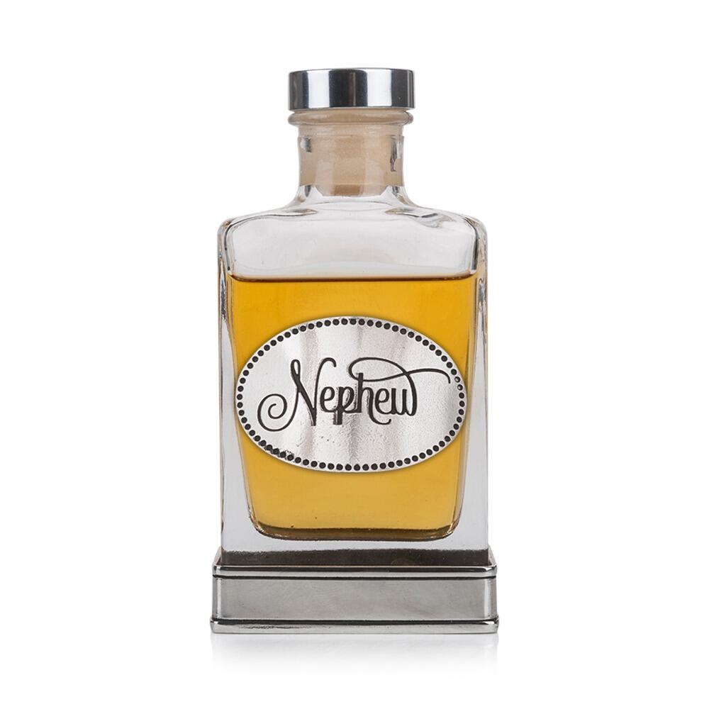 A glass flask with a pewter base and a handcrafted pewter “Nephew” emblem on the front
