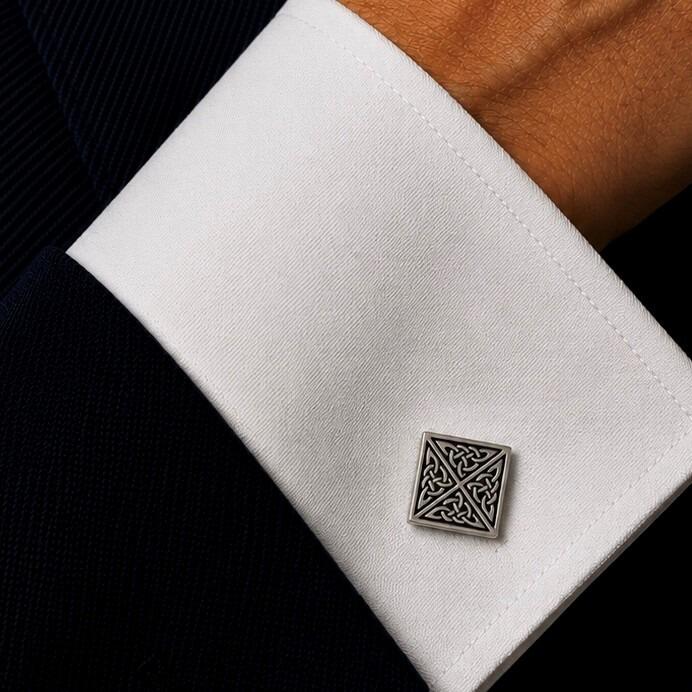 A square pewter cufflink featuring an intricate Celtic triskele triple spiral design with antiqued recessed details