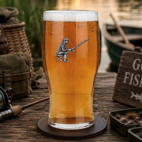 Pint glass with handmade pewter fishing badge, filled with golden beer