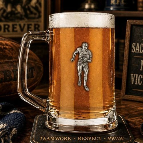 A Beer Tankard with a Pewter Rugby badge on the front, filled with Amber Beer