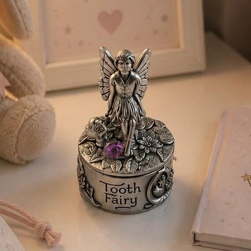 Round pewter tooth fairy box engraved with "Tooth Fairy," featuring a standing fairy figurine on the lid beside a small mushroom and a purple gemstone accent