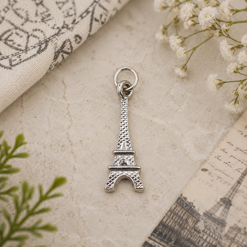 Eiffel Tower Pewter Charm with an expandable bracelet on a soft stone background