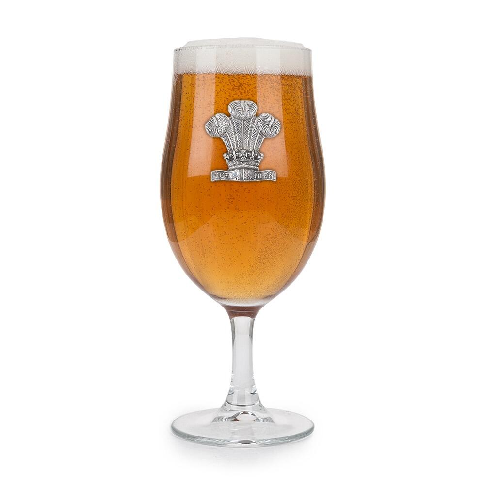 A Stemmed Pint Beer Glass with a Pewter Welsh Feathers badge on the front, filled with Beer