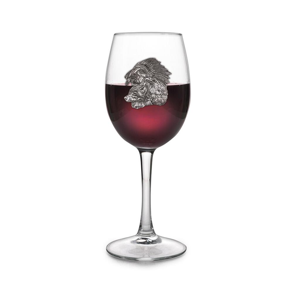 Wine glass with handmade pewter Native American cultural badge filled with red wine