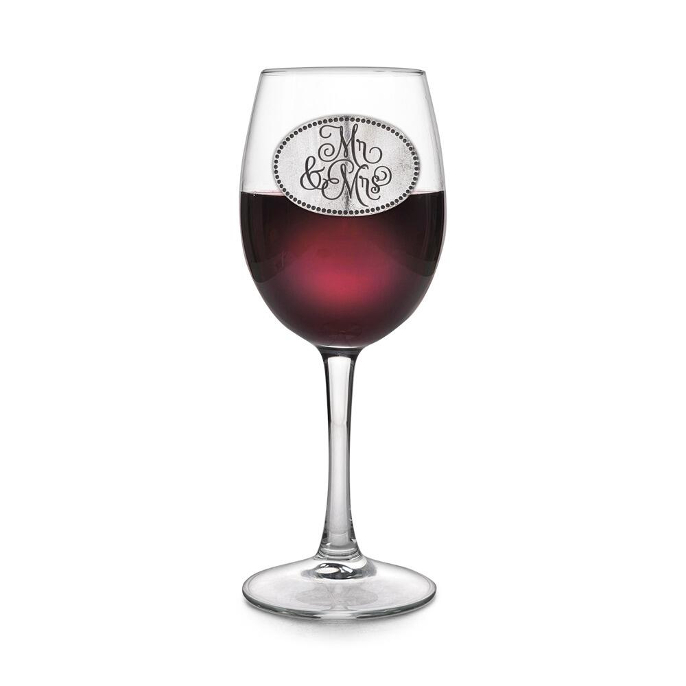 Wine glass with handcrafted pewter Mr and Mrs badge filled with red wine