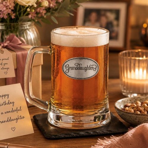 A Beer Tankard with a Pewter Granddaughter badge on the front, filled with Amber Beer