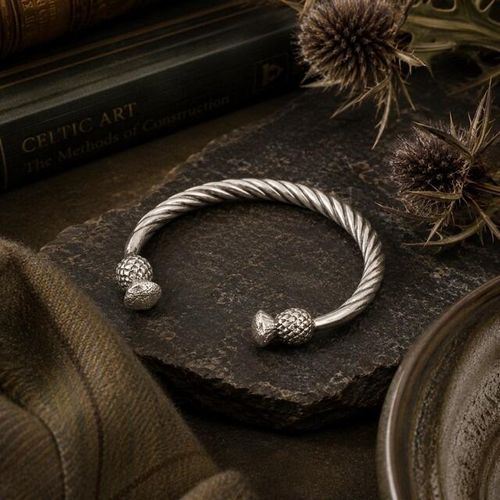 Twisted pewter torque bangle bracelet featuring detailed Scottish thistle terminals