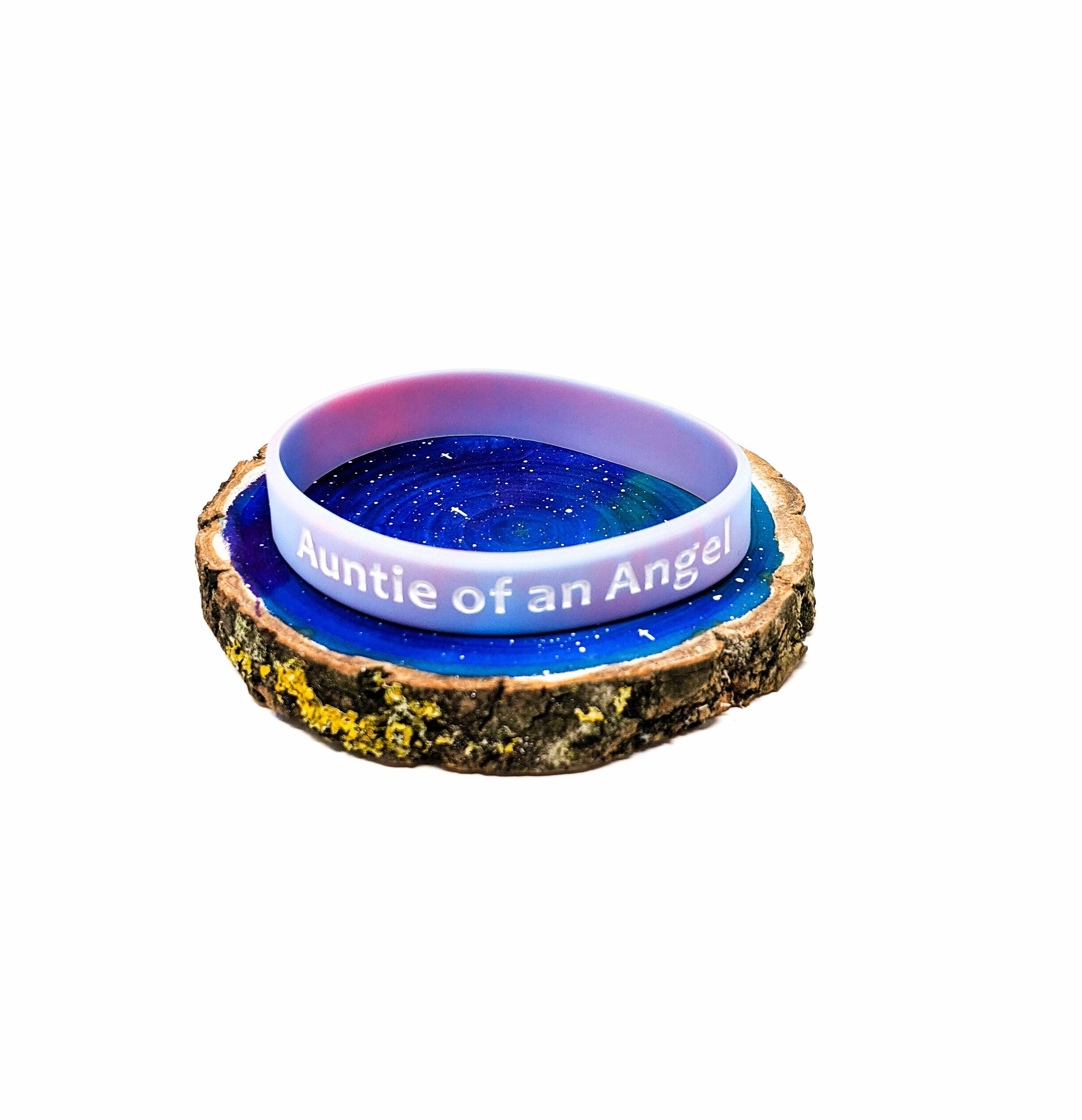 Baby loss awareness bracelet with “Auntie of an Angel” text on pink and blue marbled silicone band