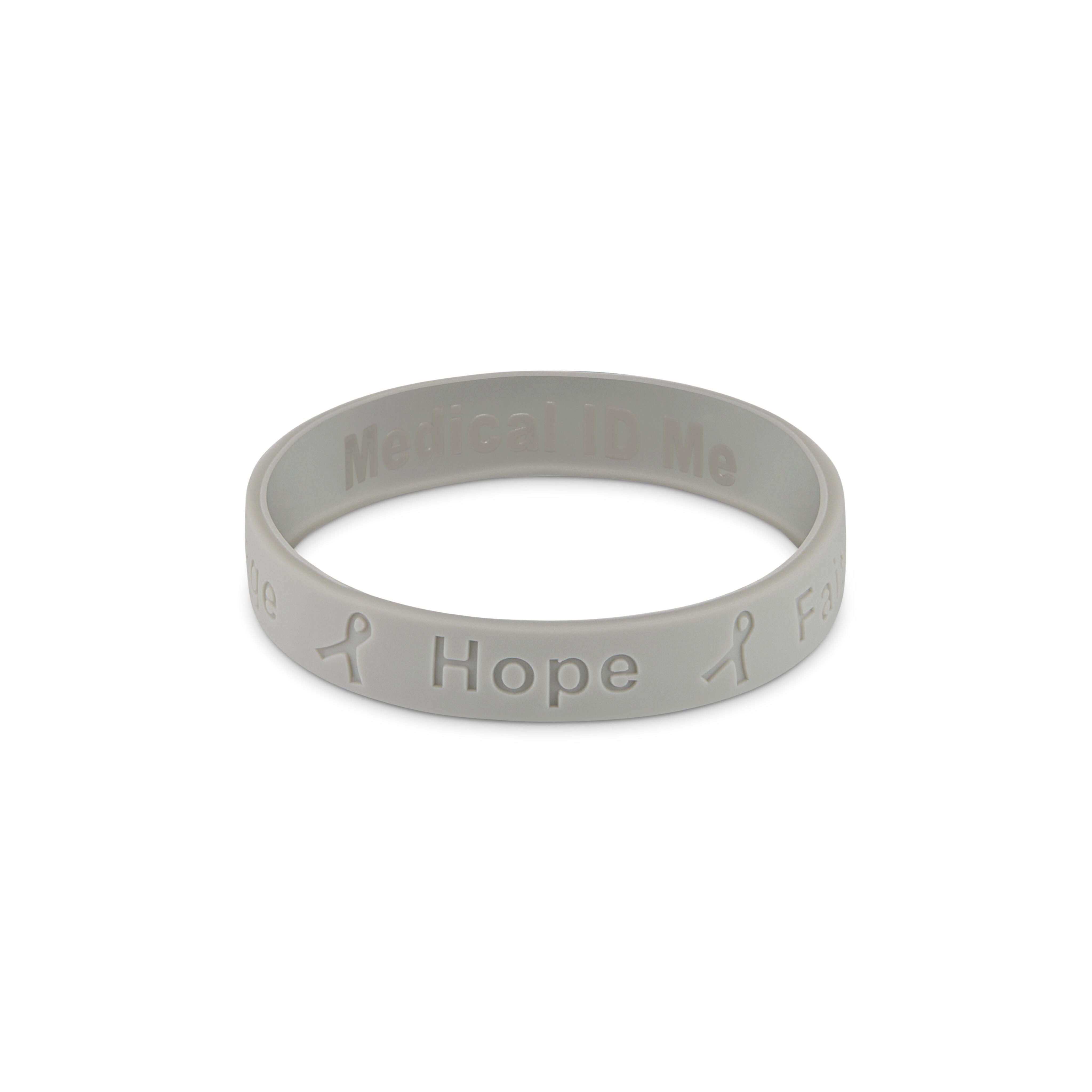 Grey silicone cancer awareness bracelet engraved with the word “Hope”.