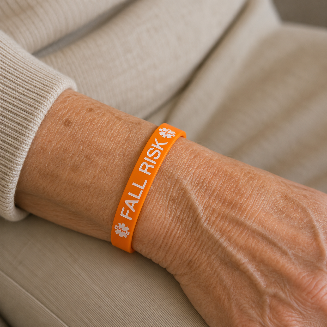 orange fall risk wristband on ladies wrist