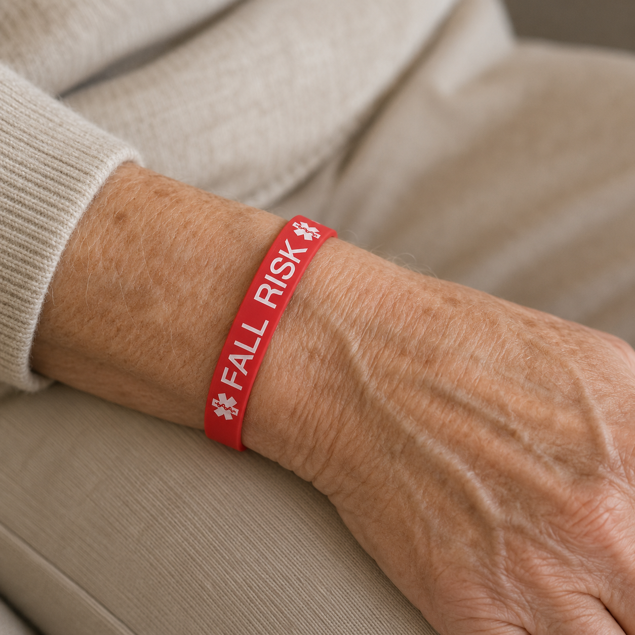 red fall risk bracelet on ladies wrist