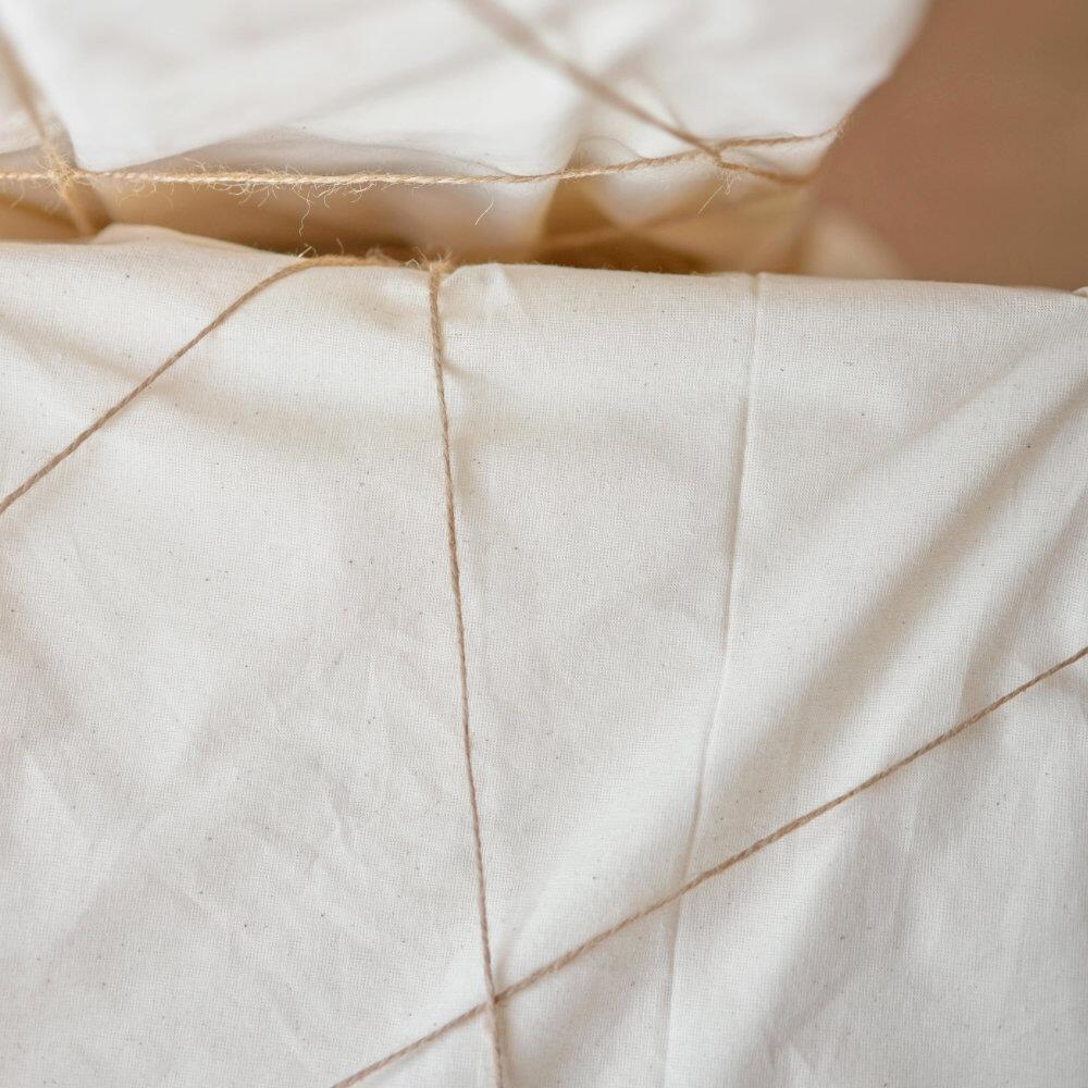 Close-up of cotton cambric lining tied over boxes with string