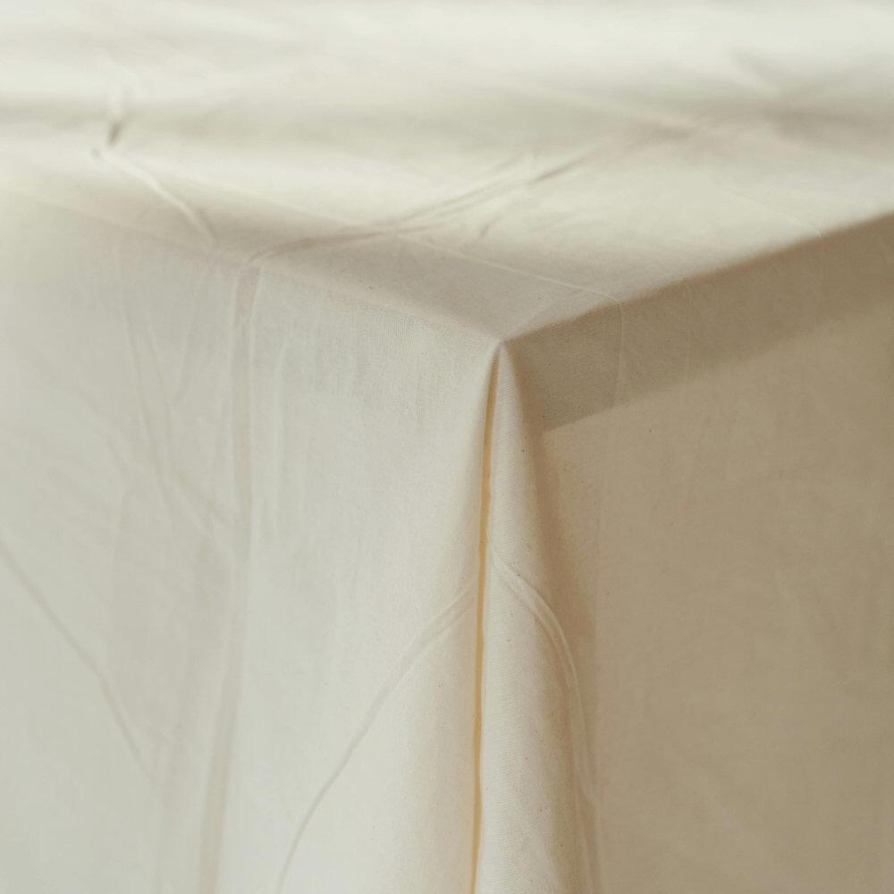 Close-up of cotton cambric fabric draped over a table edge