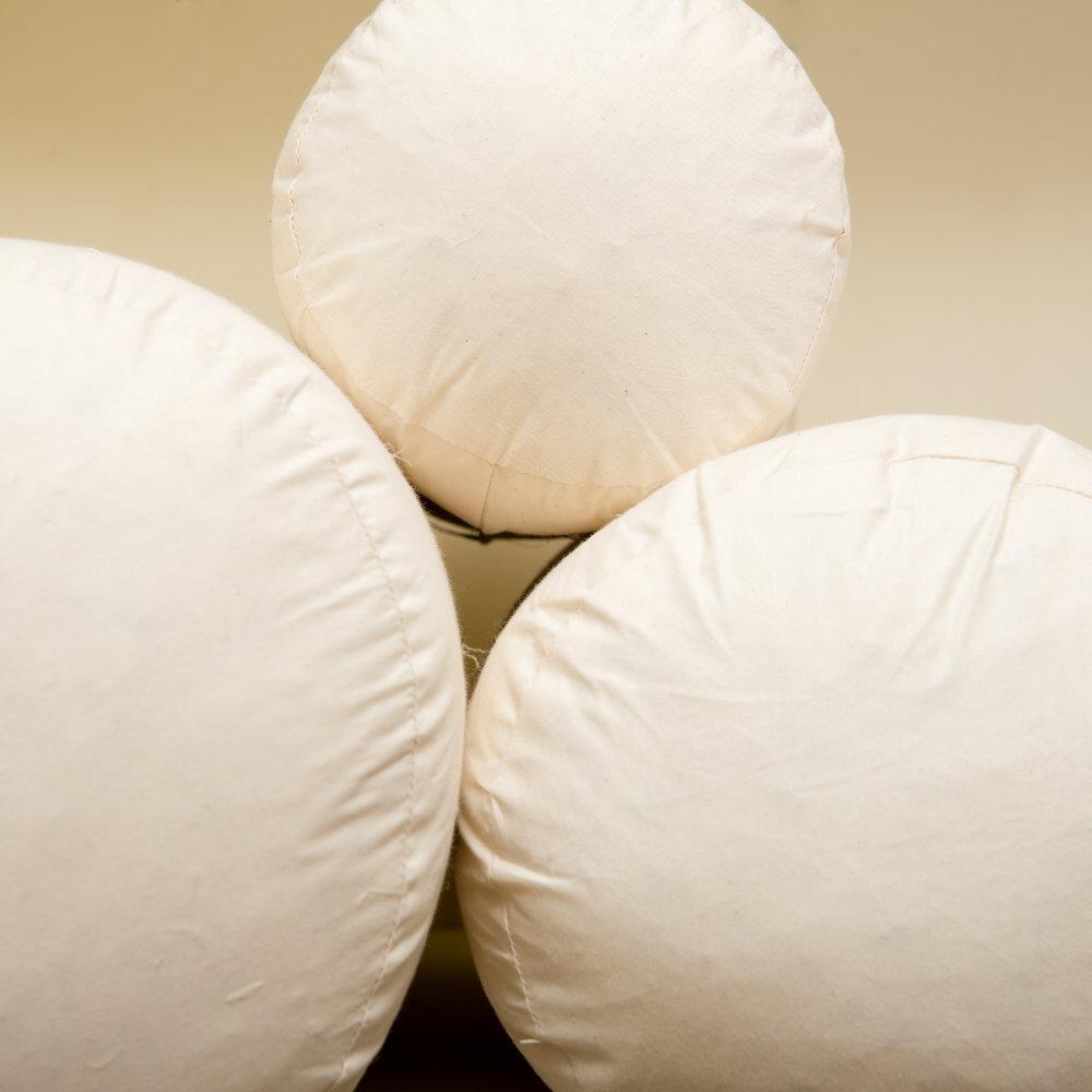 Cream bolster cushion inserts shown upright