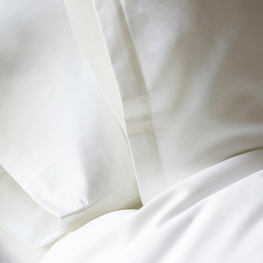 Close-up of housewife pillowcase stitching on a white v-shaped pillowcase