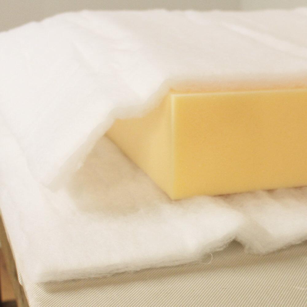 Polyester batting draped over upholstery foam