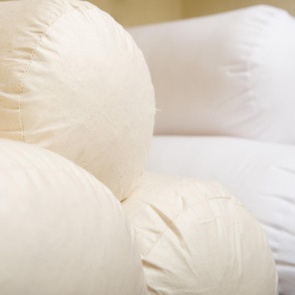 Large bolster cushion pads stacked together
