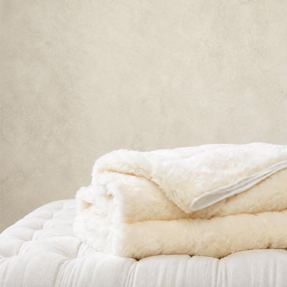 Wool mattress topper folded on buttoned cushion