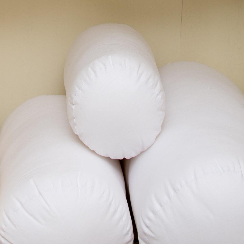 White bolster cushion inserts stacked together