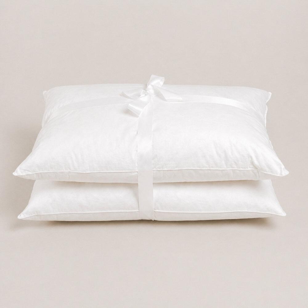 Pair of white 100% down pillows tied with ribbon