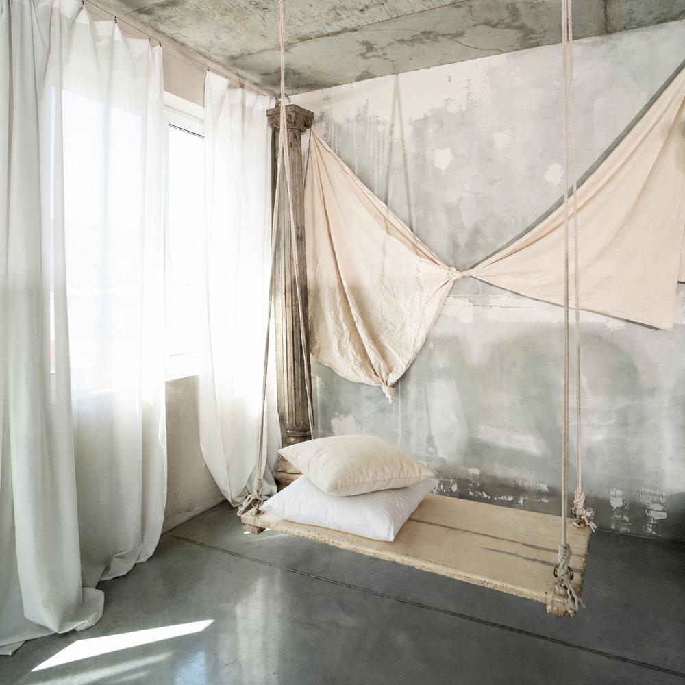 Square cushion inserts styled on a wooden swing