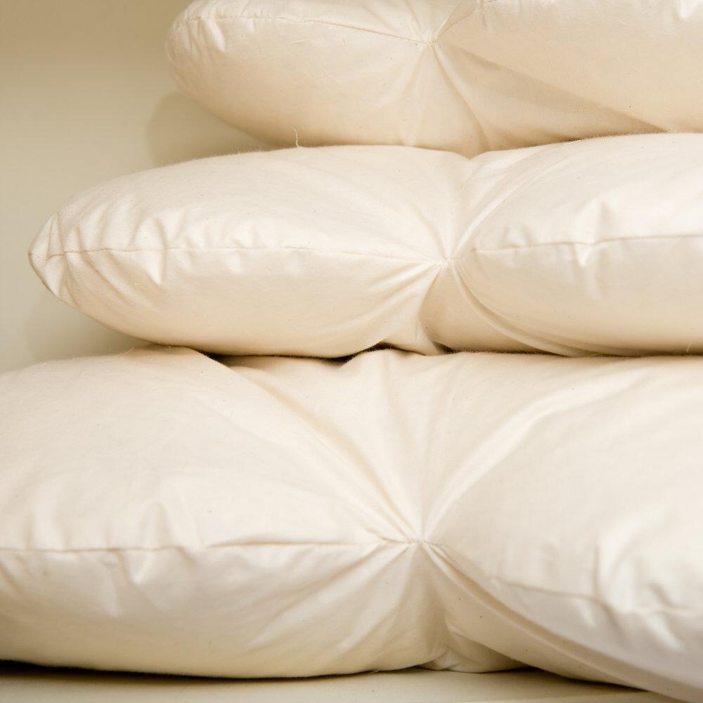 Close-up of cream heart cushion inserts stacked together