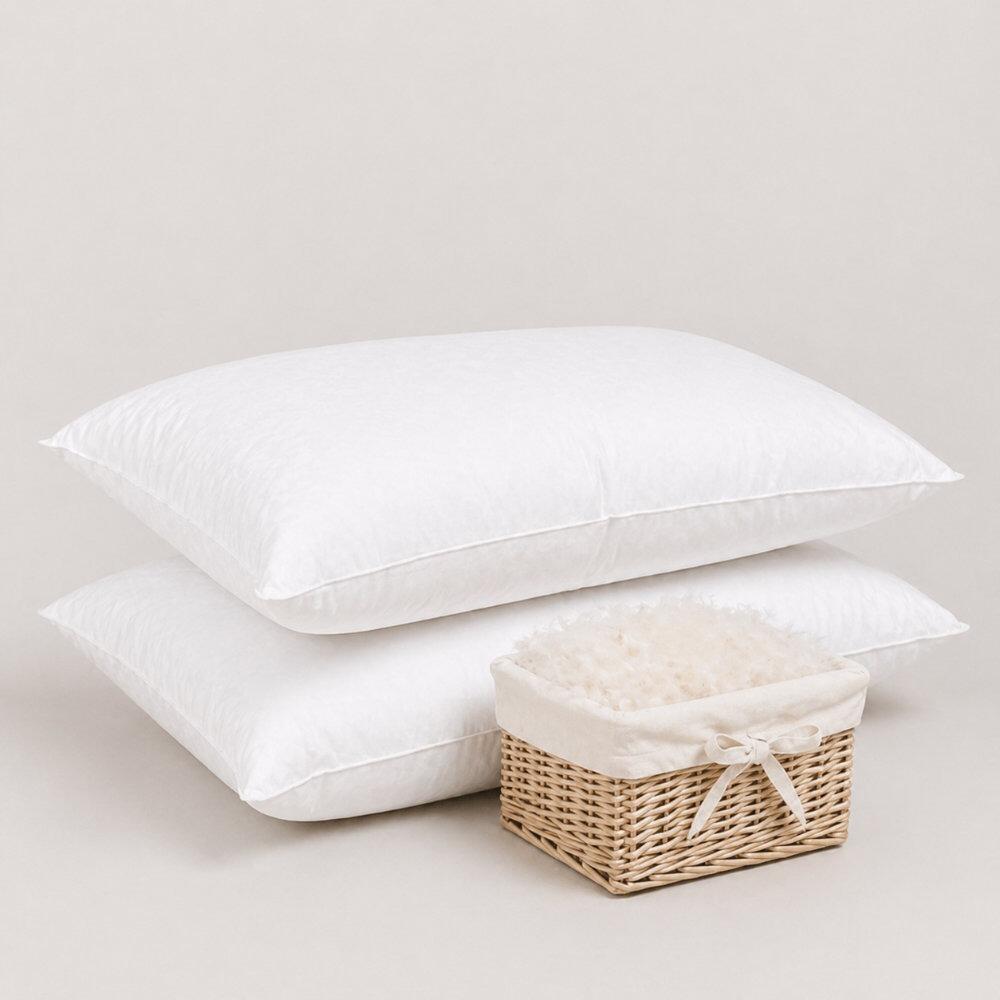 Pair of white 100% down pillows beside a basket of down filling