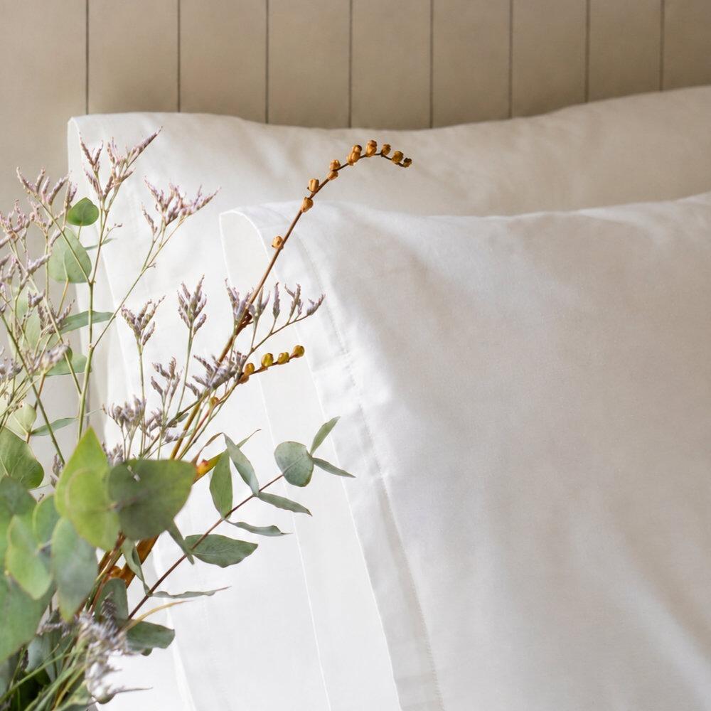 Close-up of a white body pillowcase with natural floral details