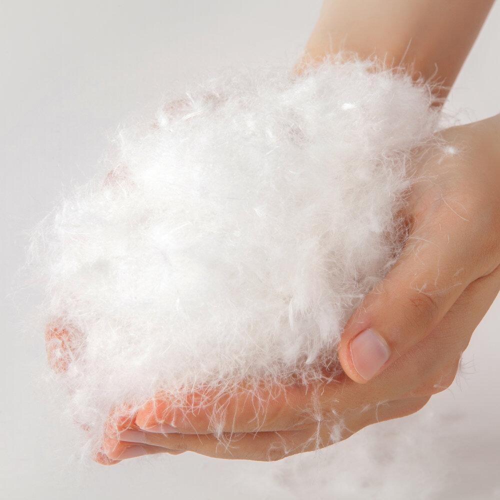 Close-up of soft pure down filling held in hand