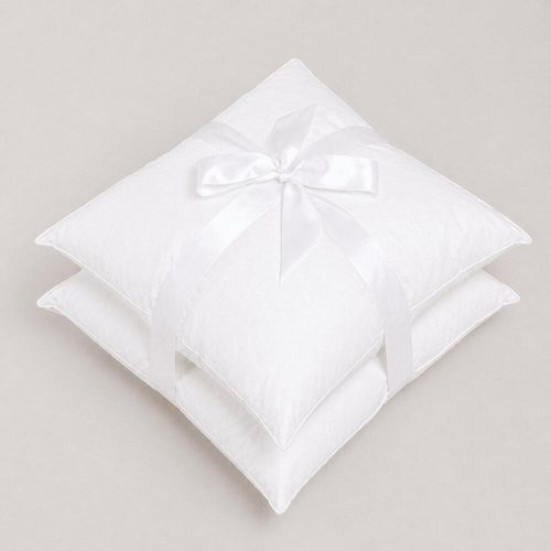 Pair of white continental fibre pillows tied with ribbon