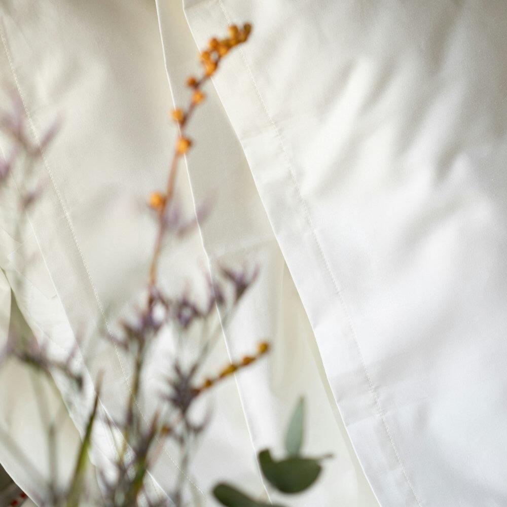 Close-up of housewife pillowcase stitching on a white body pillowcase