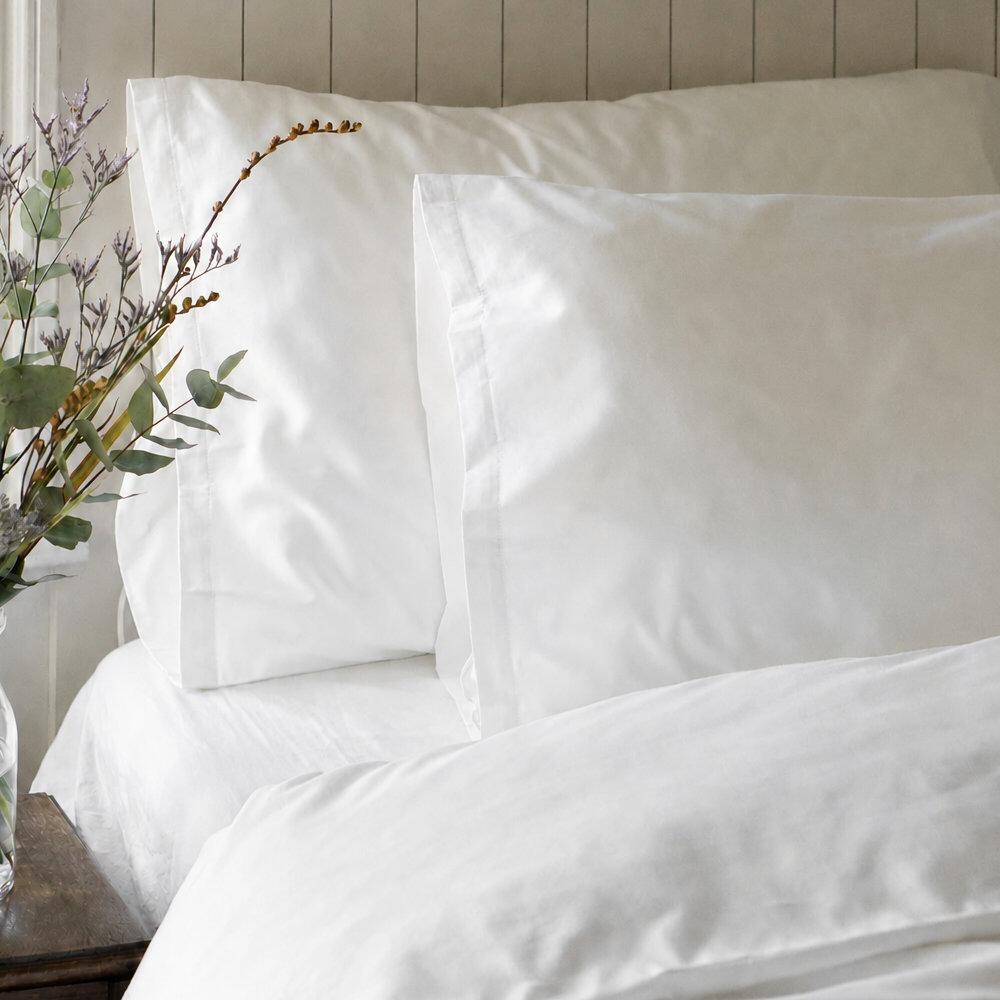 White body pillowcase on a bed with floral styling