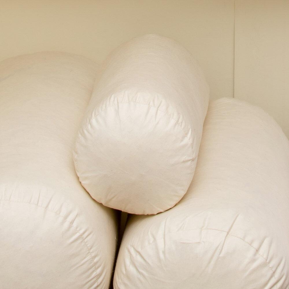 Cream bolster cushion pads stacked together