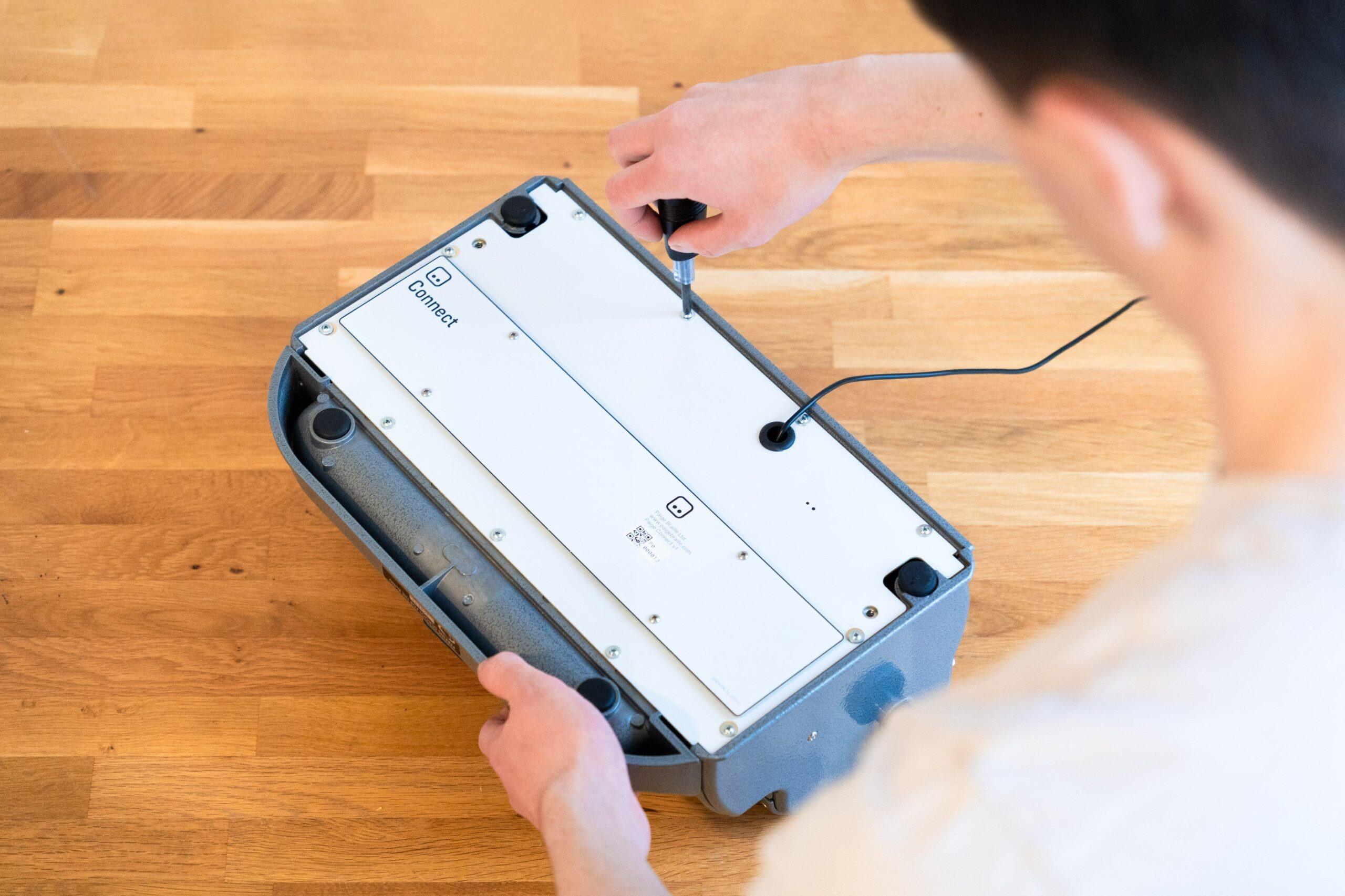 the paige connect being installed onto a perkins brailler